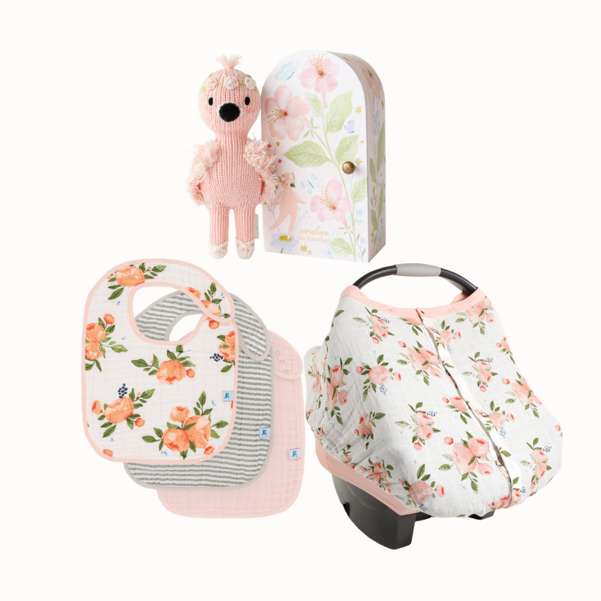 A coordinated baby accessory set on a white background, including a floral baby car seat cover, a matching floral and striped bib, a pink plush toy, and a floral storage box. Little Birdies Penelope's Watercolor Roses Gift Set